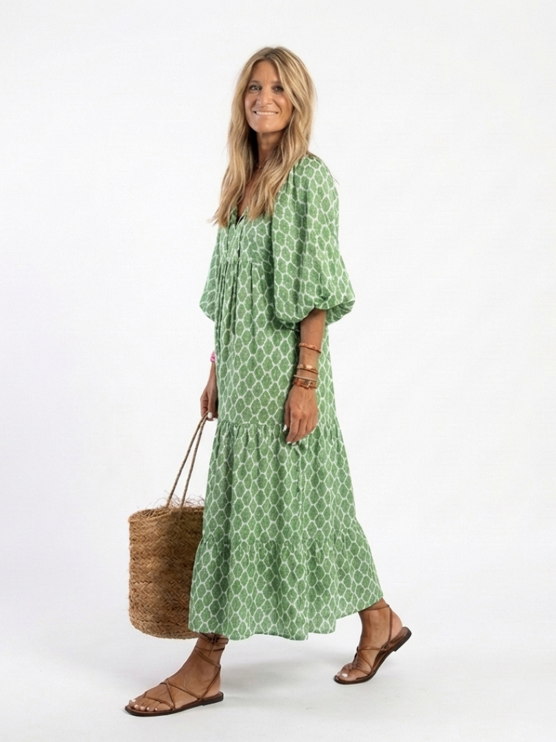 Relaxed fit women's midi dress. Green patterned V neck, three-quarter sleeves. Perfect for spring casual wear.