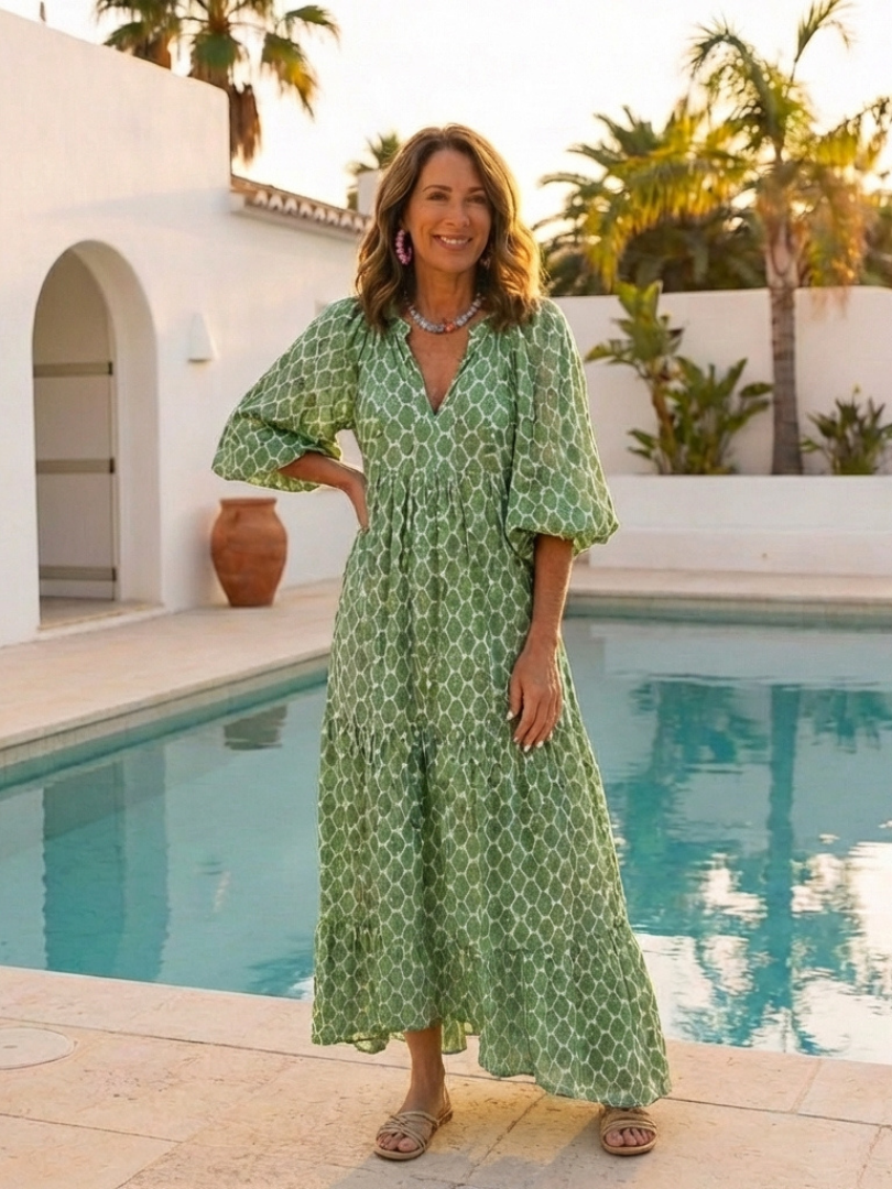 Purple patterned midi dress with V neck and three-quarter sleeves. Comfortable, flowy women's spring casual dress.