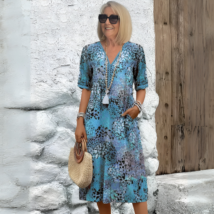 Women's V-neck relaxed fit midi dress with an elegant abstract print, perfect for summer casual wear.