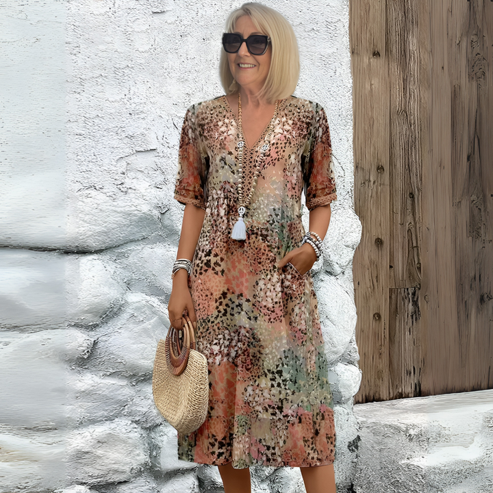 Elegant women's summer midi dress with a flattering V-neck, relaxed fit, and unique abstract print for versatile fashion.