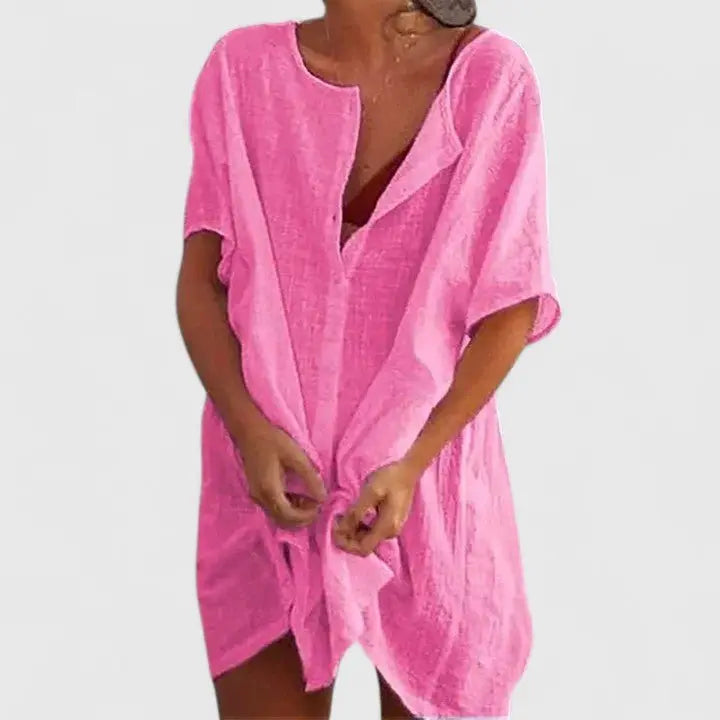 Woman wearing a comfortable V-neck relaxed fit summer tunic dress, perfect for warm days.