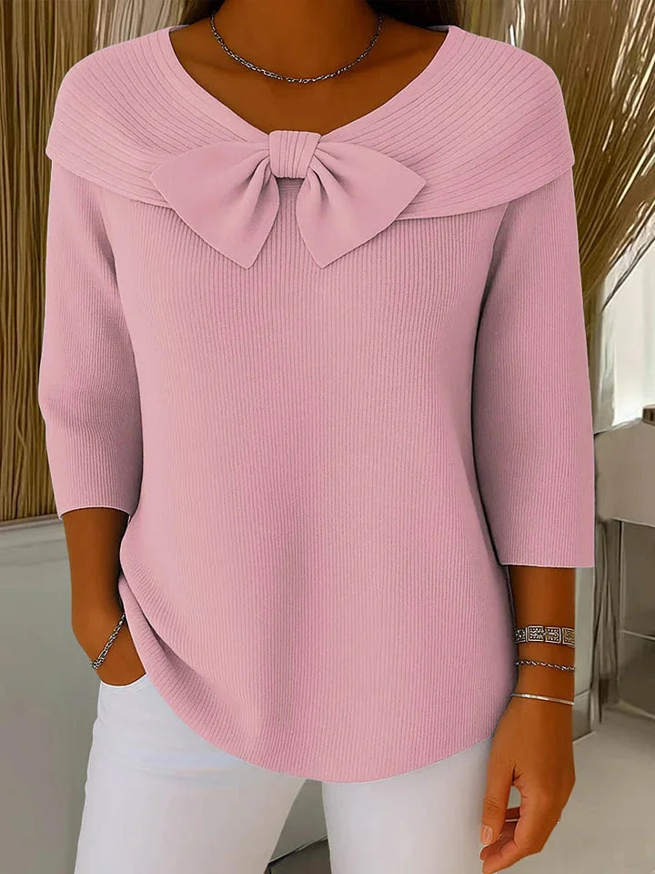 Soft women's ribbed knit V-neck sweater with bow accents & 3/4 sleeves, offering comfort & fashion.