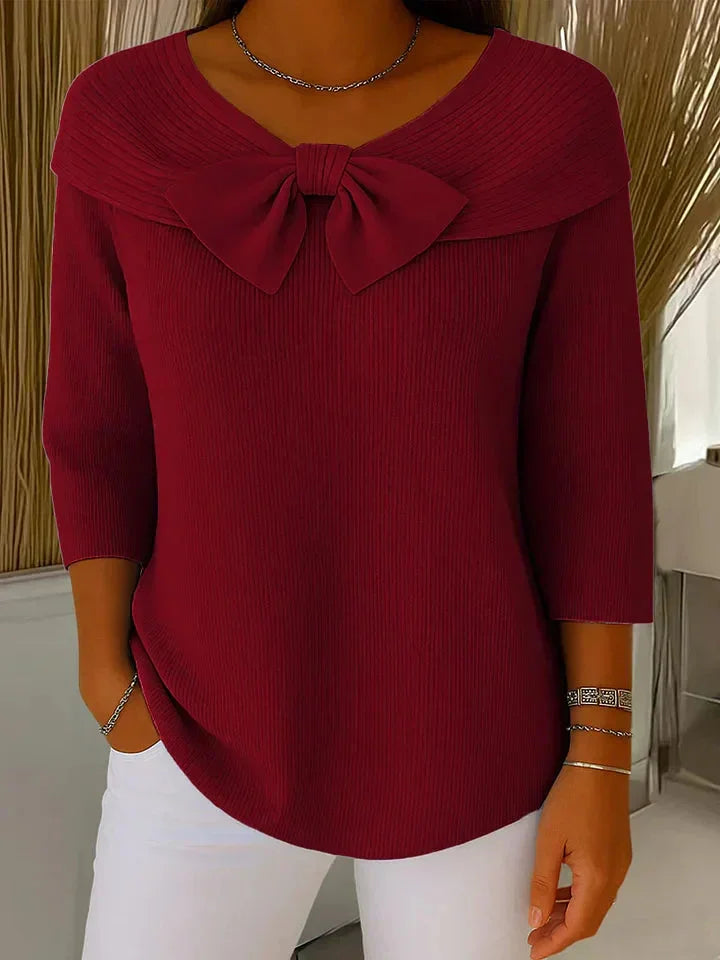 Women's elegant V-neck ribbed knit sweater with 3/4 sleeves and a charming bow detail.