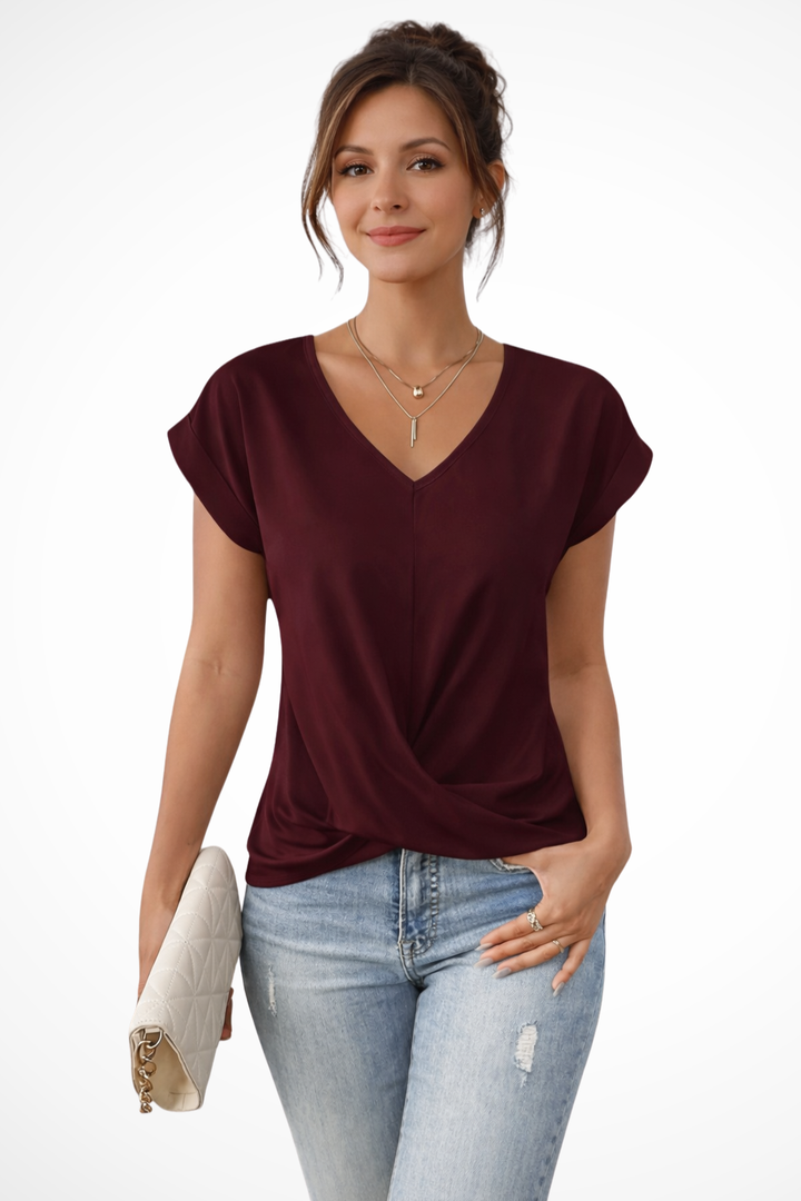 Women's V-neck short sleeve top with stylish twist hem. Effortless casual comfort for spring.