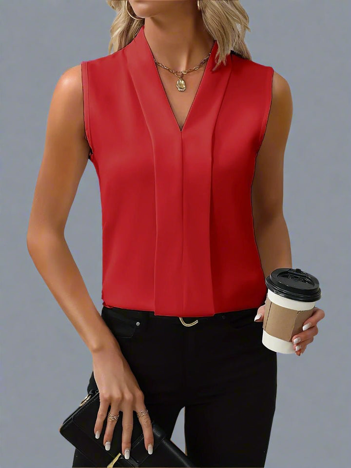 Sleeveless V-neck pleated blouse with stand collar for women. An elegant & versatile professional top for office wear.