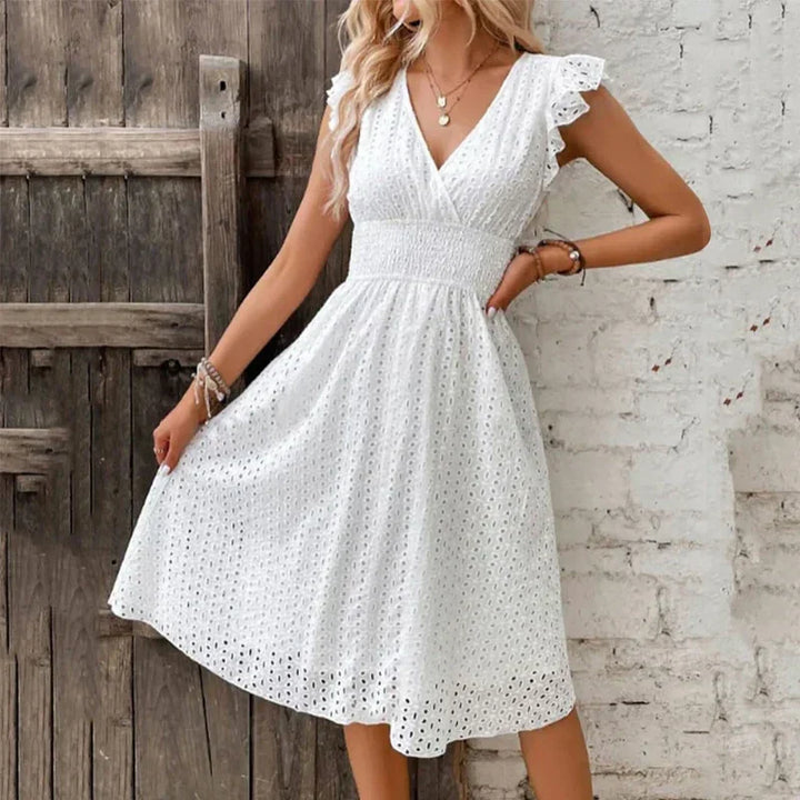 Elegant V-neck midi dress with smocked waist & ruffle sleeves, ideal for beach or summer fashion.