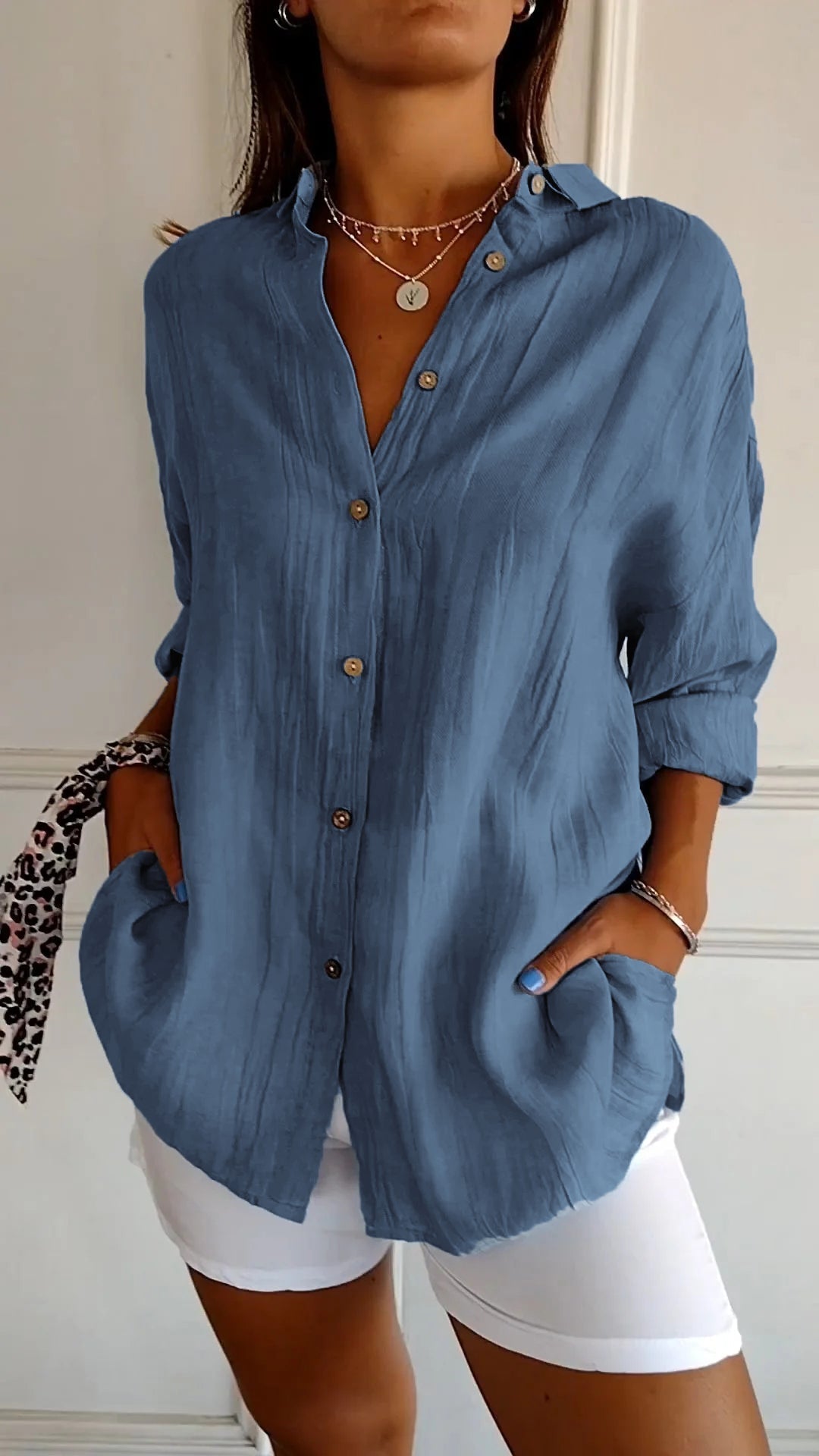 Chic women's button-down shirt with roll-up sleeves, versatile for any occasion.