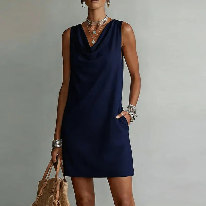 Sleeveless A-line mini dress for women, featuring a draped cowl neck & relaxed fit, perfect for everyday chic.