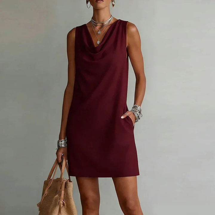 Chic women's cowl neck mini dress with handy pockets, offering versatile smart casual or everyday summer style.