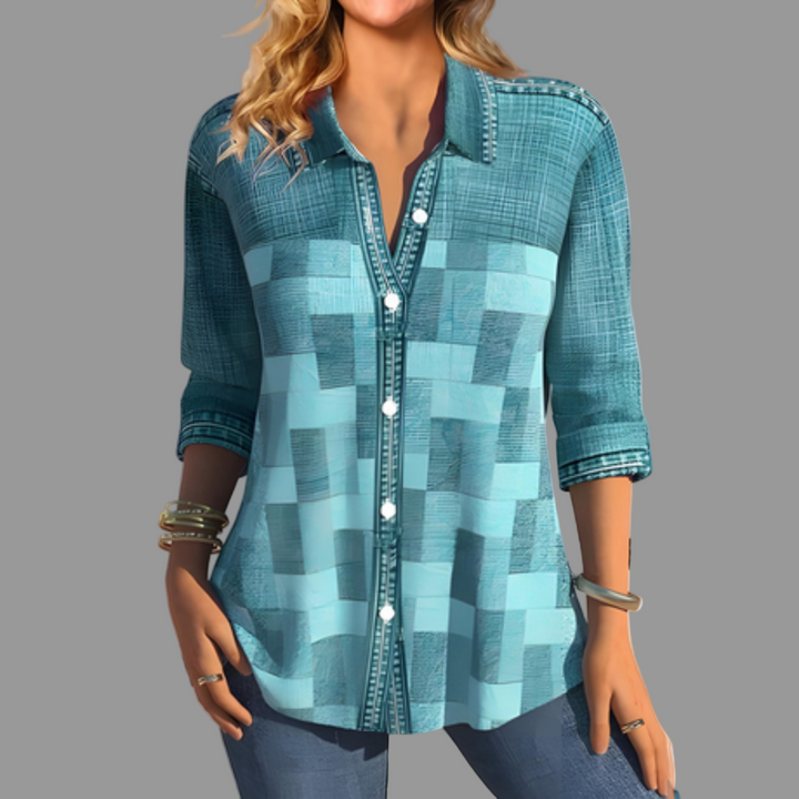 Denim blue long sleeve button-front blouse for women, featuring a classic collar. Great for layering and transitional style.