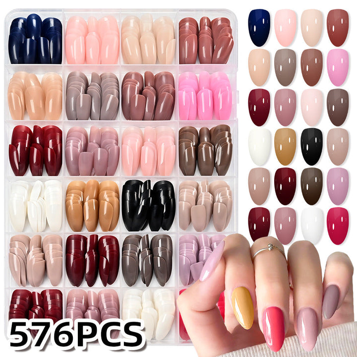 Assorted press-on nail tips for women, offering various styles & colors for quick DIY nail art & beauty.