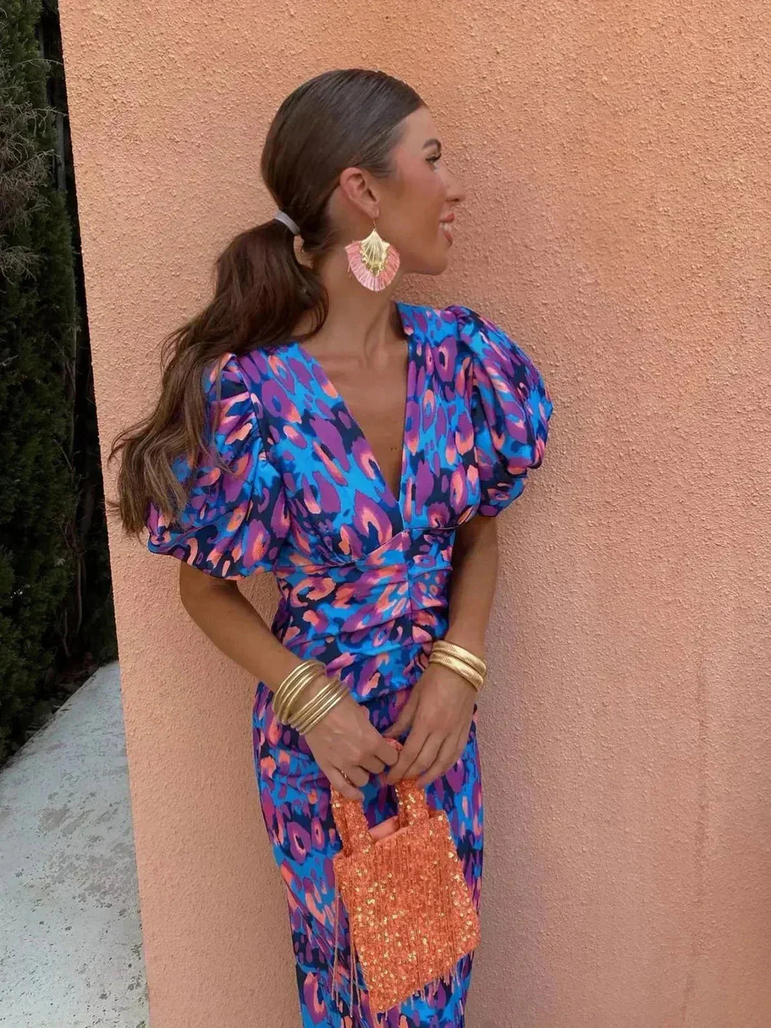Women's vibrant abstract print midi dress with elegant V-neck and stylish puff sleeves, perfect for parties.