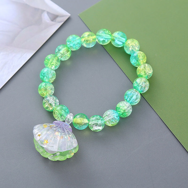 Women's vibrant beaded bracelet with a natural shell pendant. Perfect summer fashion accessory.