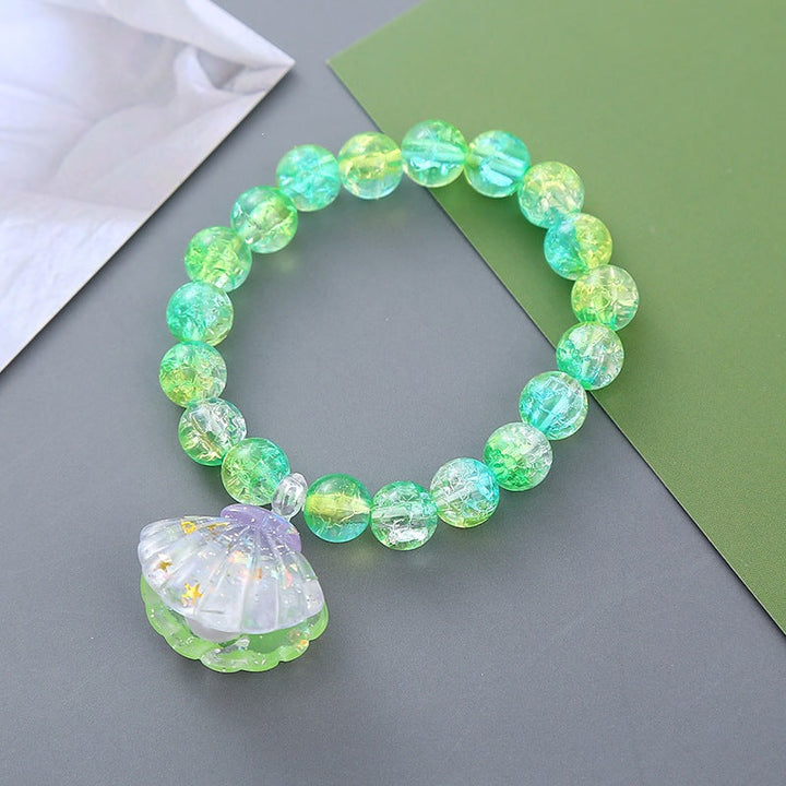 Women's vibrant beaded bracelet with a natural shell pendant. Perfect summer fashion accessory.