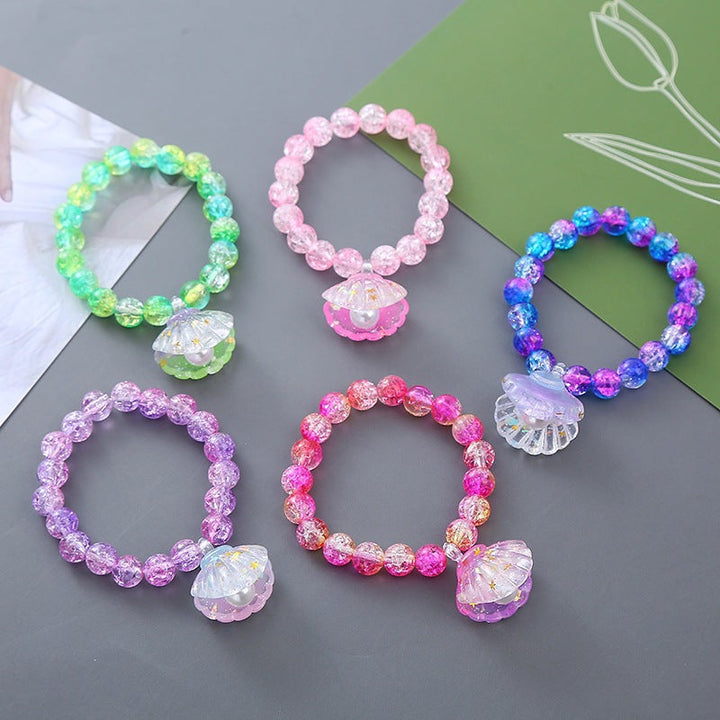 Colorful beaded bracelet for women, featuring a delicate shell pendant. Ideal beach & summer jewelry.
