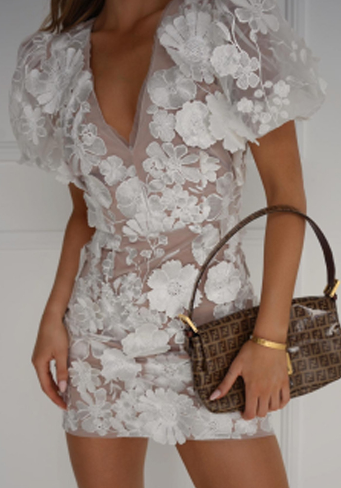 Chic women's floral mini dress, perfect for warm weather fashion, embodying a playful yet elegant style.