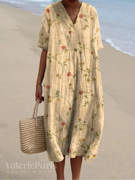 Vibrant women's summer dress with a flowy floral design, perfect for beach or vacation.