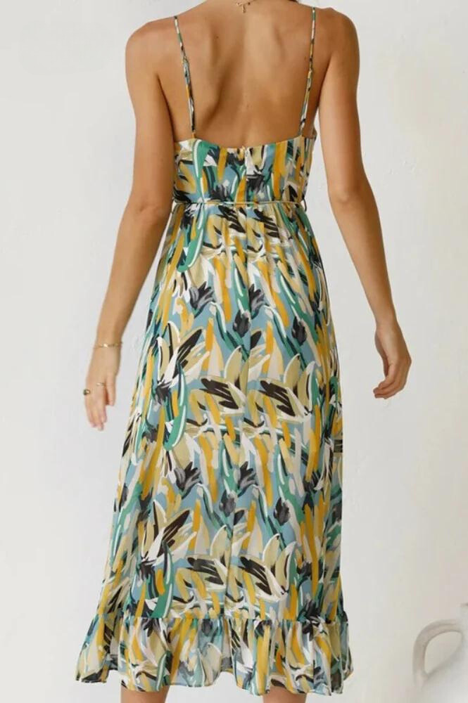 Woman twirling in vibrant flowy midi dress, showcasing its elegant movement & colorful design for summer.