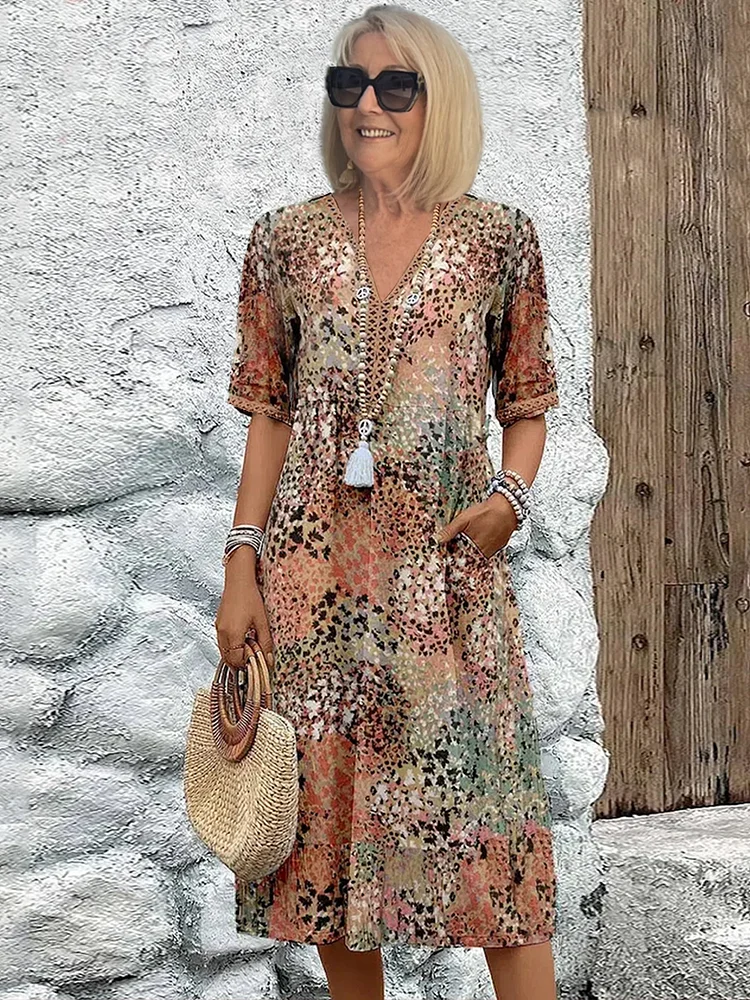 Close-up of vibrant pattern on a flowing women's midi dress, showcasing elegant spring/summer style.