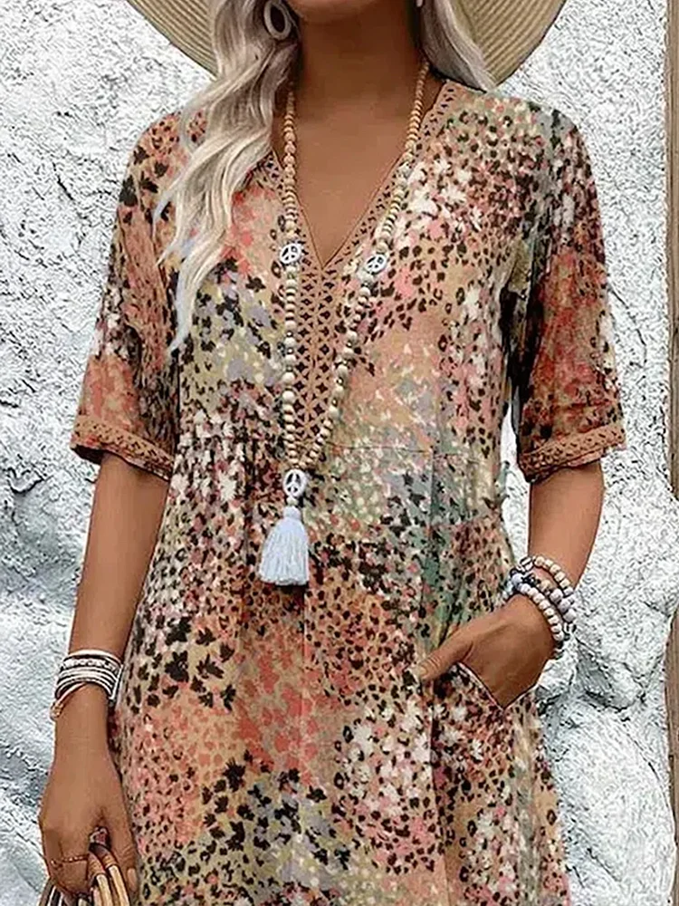 Model wearing elegant women's vibrant pattern midi dress, flowing style for stylish summer fashion.