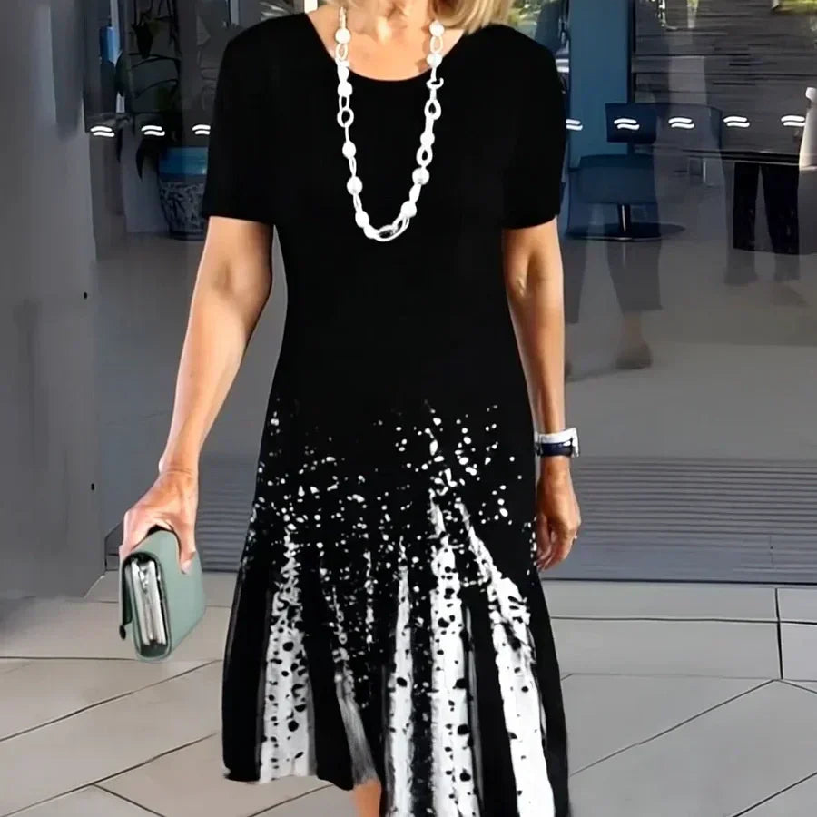 Women's vibrant printed A-line midi dress with short sleeves, perfect for summer casual wear and comfort.
