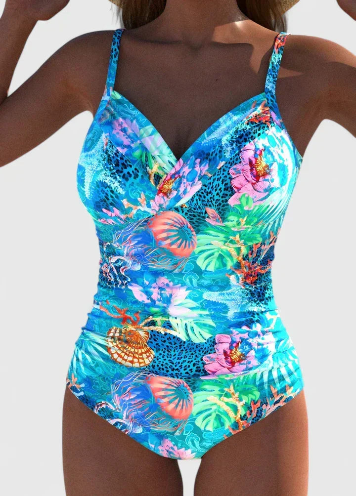 Women's vibrant tropical print one-piece swimsuit for beach or poolside. Perfect summer beachwear.