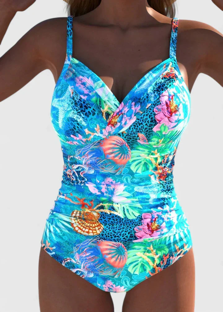 Cyan tropical printed women's one-piece swimwear. Ideal for summer vacations, holidays, and the beach.