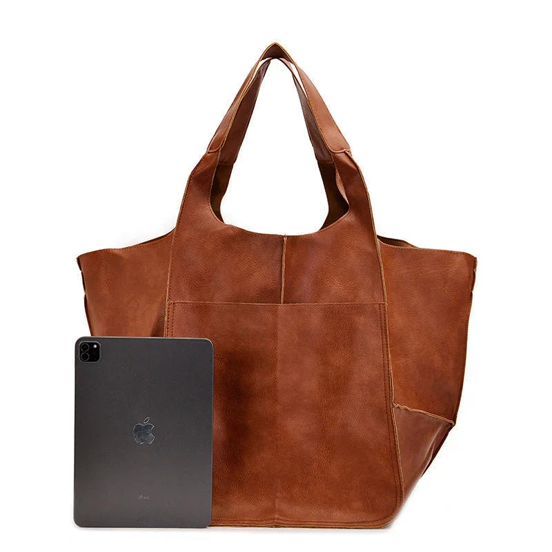 Women's vintage brown leather oversized shoulder bag, a timeless fashion accessory for everyday use.