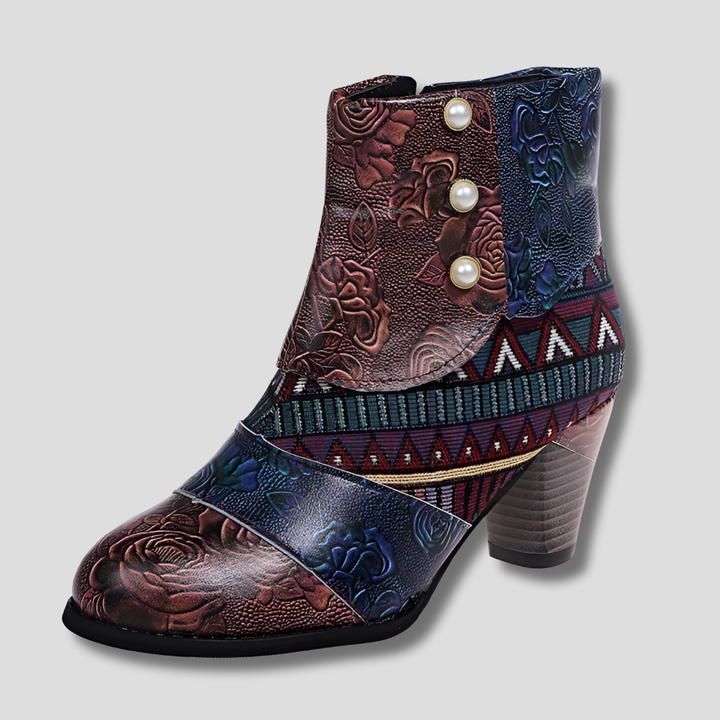 Close-up of women's retro embossed floral ankle boots. Vintage chunky heel and comfortable pull-on design for casual wear.