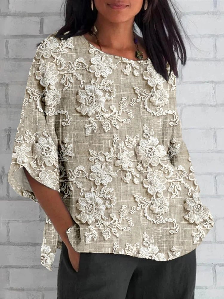 Women's vintage floral embroidered 3/4 sleeve blouse, relaxed fit. Elegant boho chic top for spring and summer fashion.