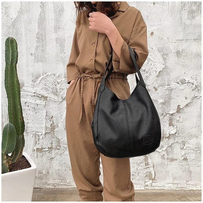 Black genuine leather hobo shoulder bag. Women's vintage, versatile handbag for everyday use.