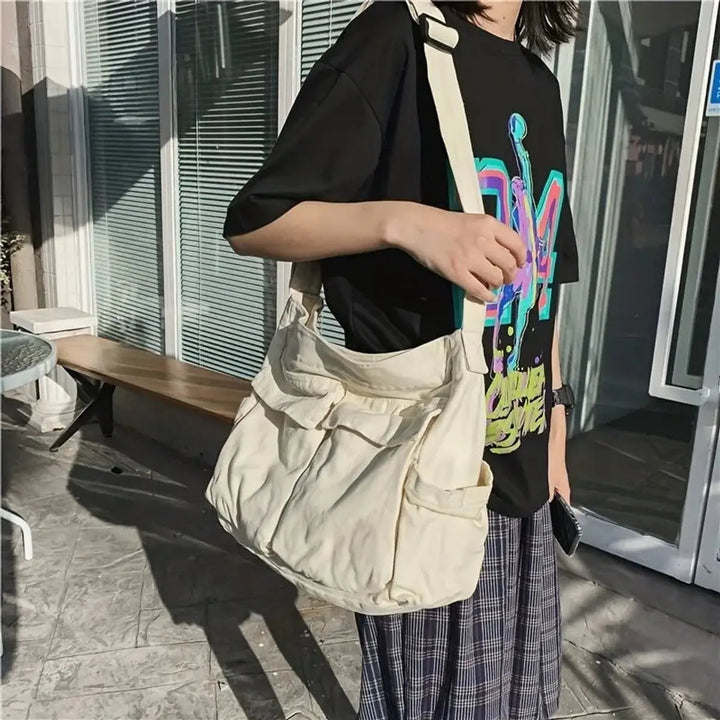 Detailed view of a women's vintage canvas multi-pocket handbag, showcasing its durable fabric & design.