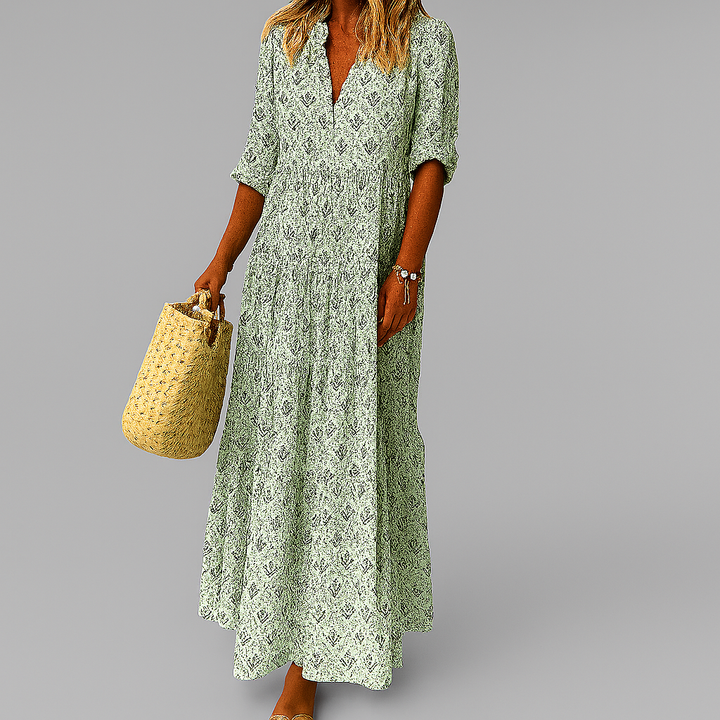 Boho style women's lightweight maxi dress. Features a vibrant vintage print, v-neck, and flowy 3/4 sleeves for summer.