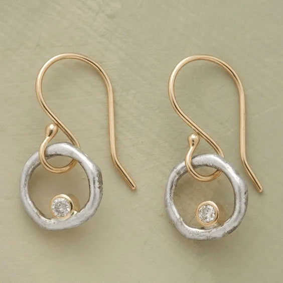 Women's vintage silver dangle earrings featuring sparkling zirconia stones and stylish textured rings.