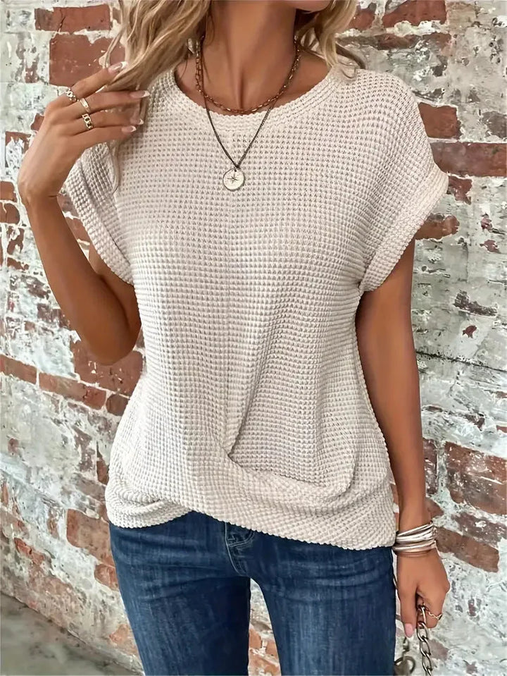 Comfortable women's waffle knit short sleeve sweater, designed with a stylish front twist detail.