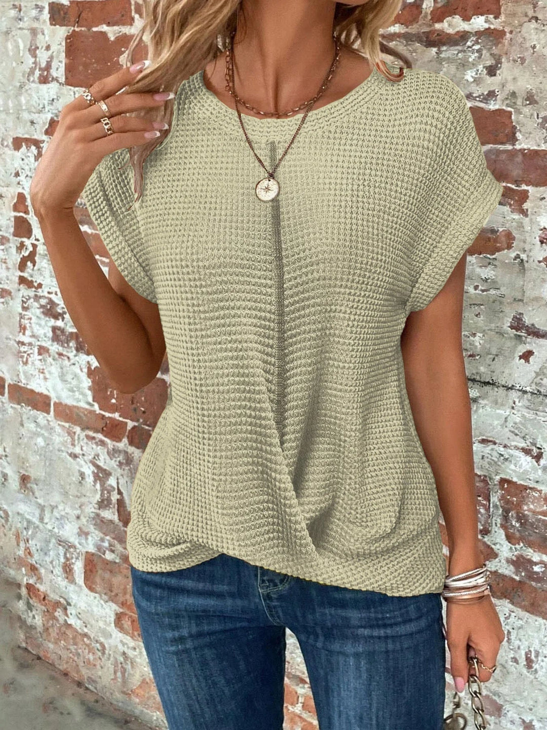 Womens crew neck short sleeve waffle knit sweater. Features a stylish and flattering front twist design.