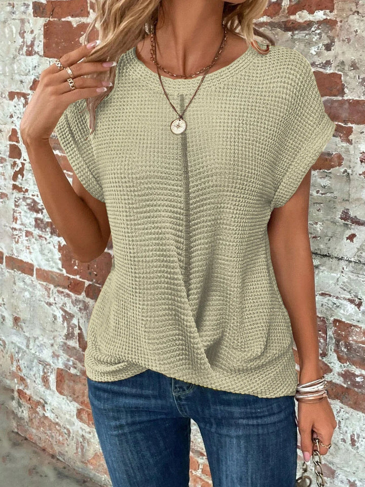 Womens crew neck short sleeve waffle knit sweater. Features a stylish and flattering front twist design.