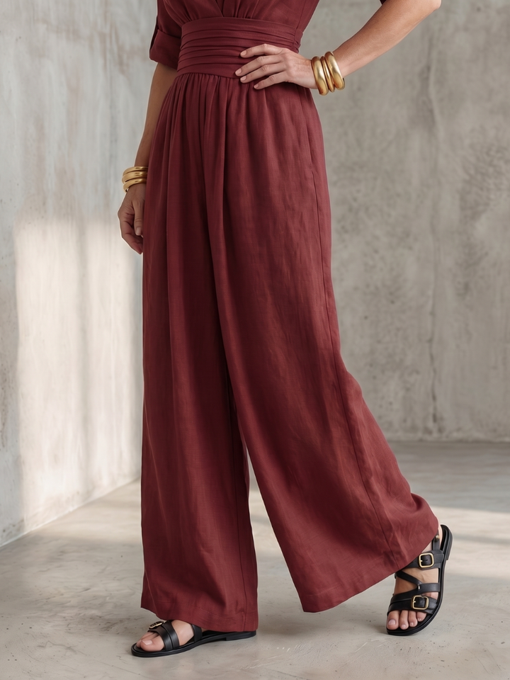 Model wearing a white cross front wide leg jumpsuit, showcasing comfortable summer style.