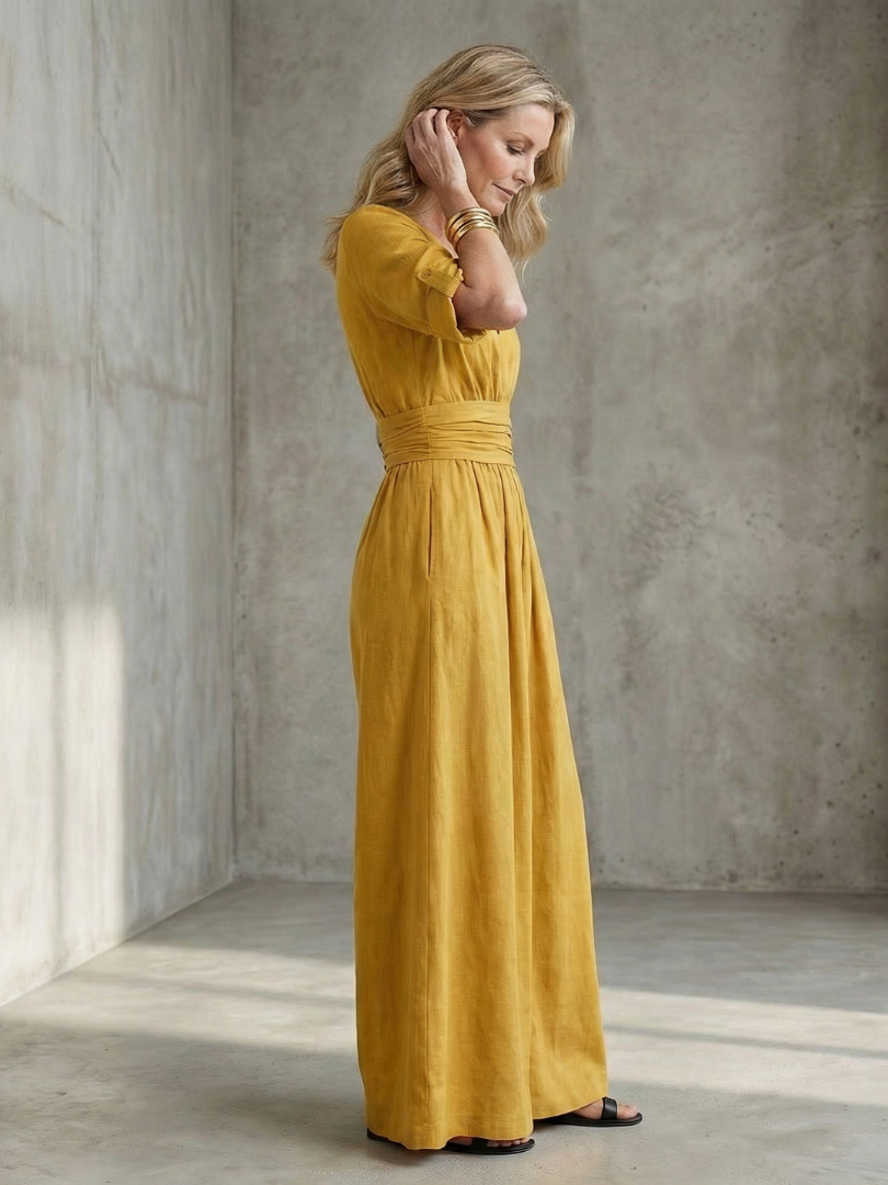 Chic yellow Wanda jumpsuit with a stylish cross front & wide leg design for women.