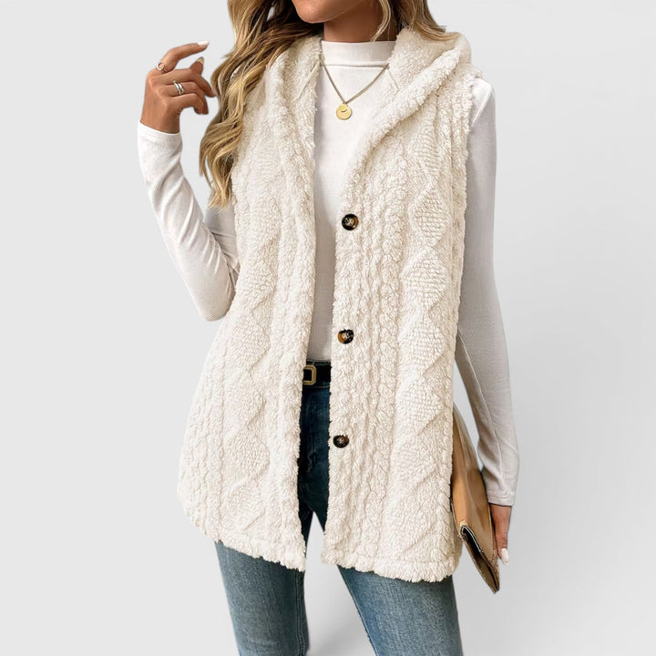 Cozy hooded sleeveless jacket for women, featuring a classic button front.
