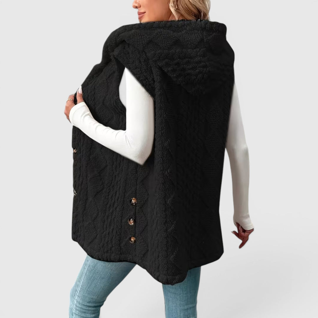 Cozy women's hooded outerwear vest, features a stylish button closure.