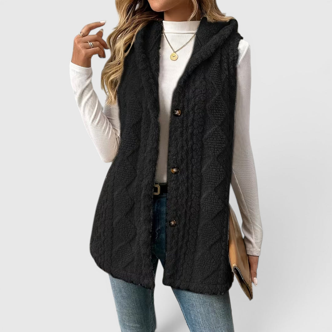 Warm women's layering vest with a hood and secure button front.
