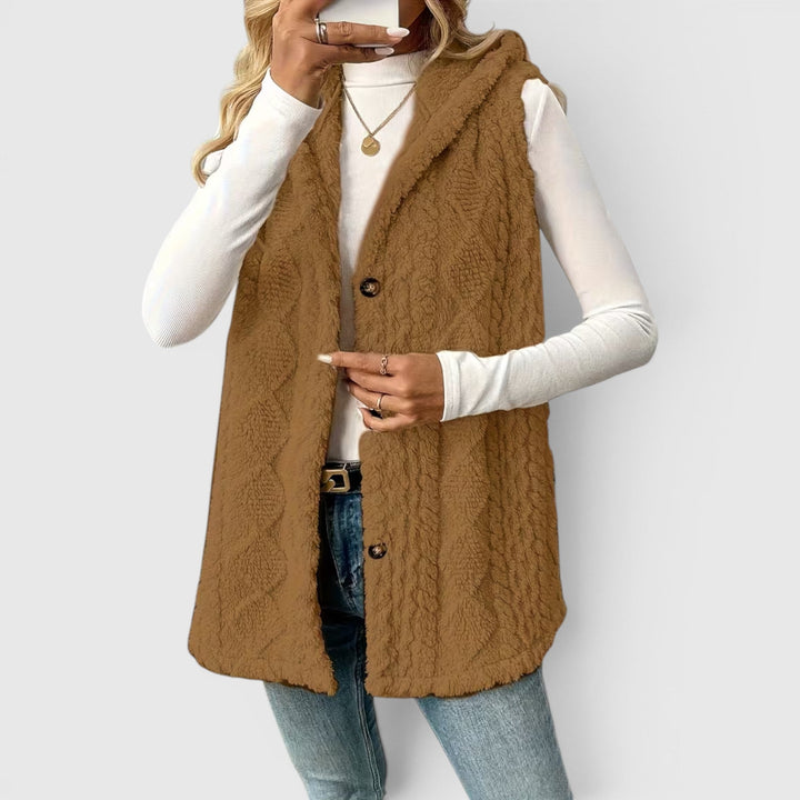 Versatile women's hooded vest, button-front closure for a snug fit.