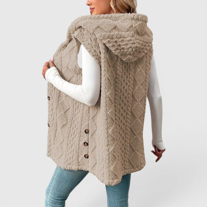 Women's versatile outerwear vest, button-front and hooded for extra warmth.