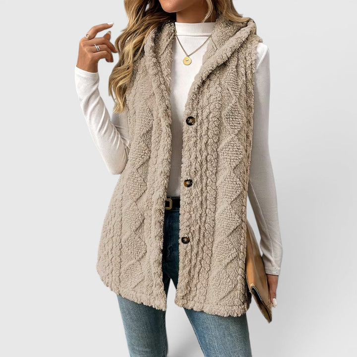 Women's warm layering vest, button front and hood for ultimate comfort.