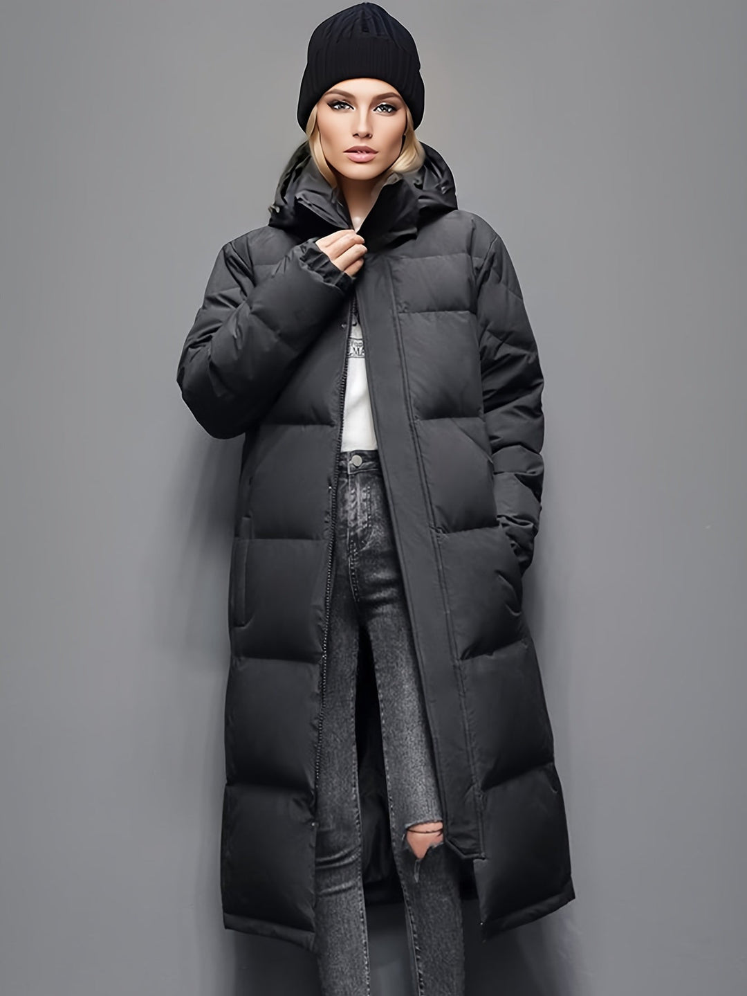 Elegant women's long padded coat with hood, delivering cozy warmth and stylish outerwear for winter.
