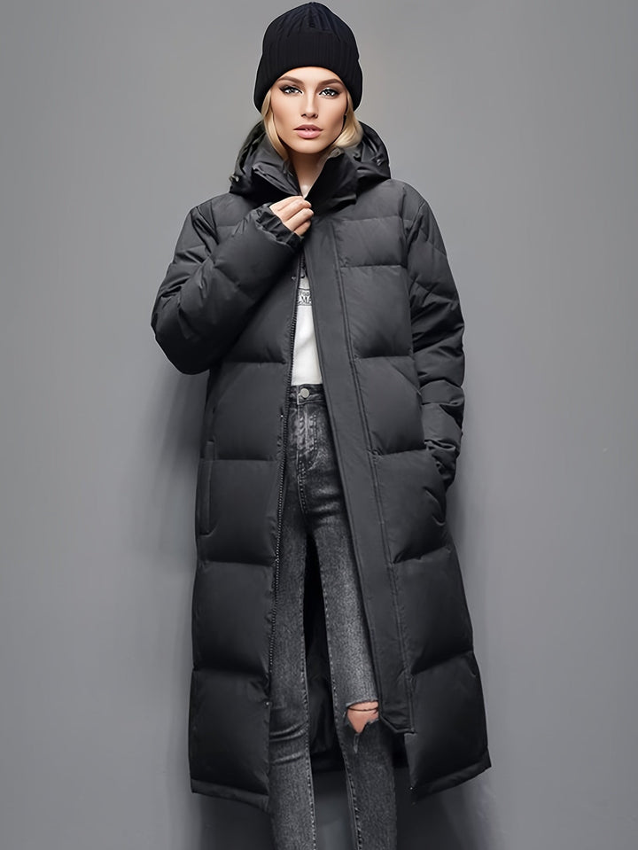 Elegant women's long padded coat with hood, delivering cozy warmth and stylish outerwear for winter.