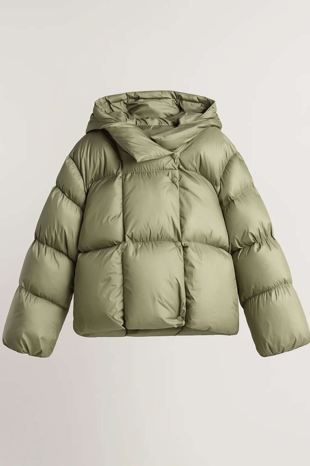 Modern women's voluminous puffer jacket, a warm and trendy winter coat for a casual yet chic look. Fashion outerwear.