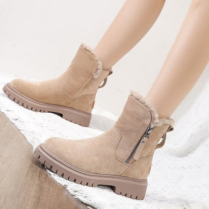 Stylish women's black slip-on ankle boots with a trendy chunky platform sole, perfect for casual winter outfits.