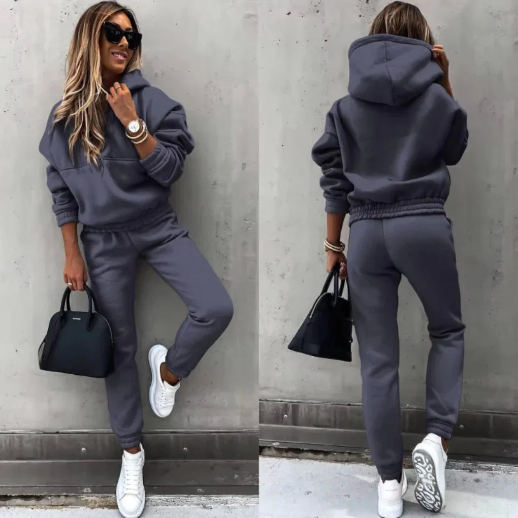 Stylish women's warm tracksuit, a two-piece winter outfit with a comfy zip jacket and joggers.